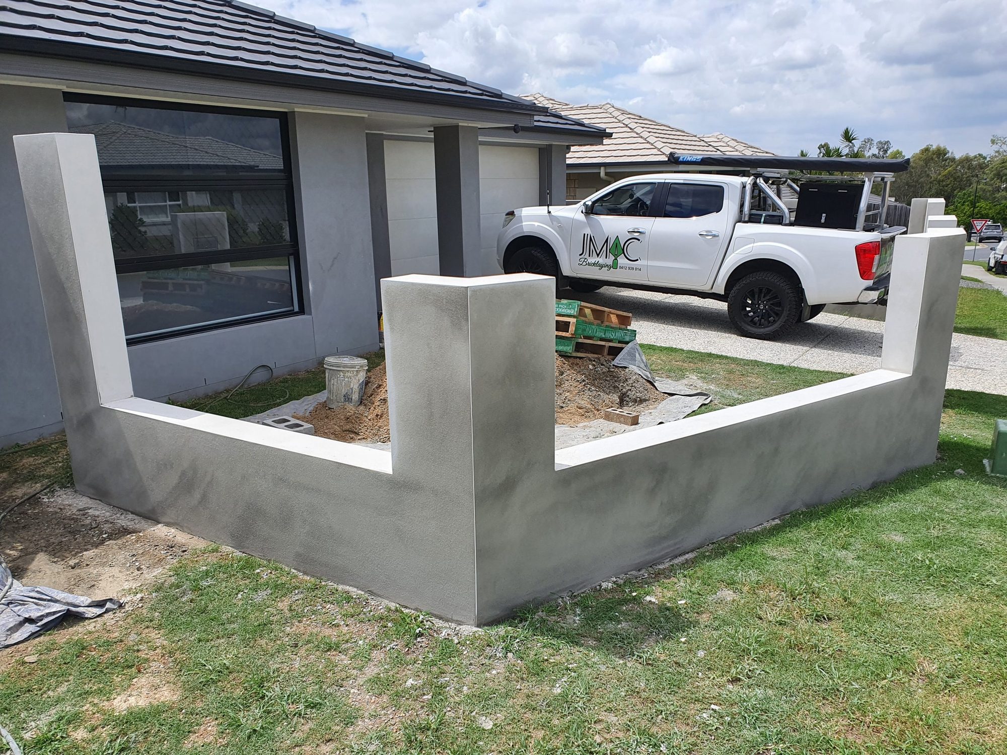 Rendered besser-block retaining wall corner by JMAC